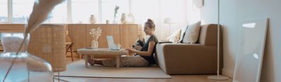 Working on laptop at the beach, Modern Workplace | DXC Technology